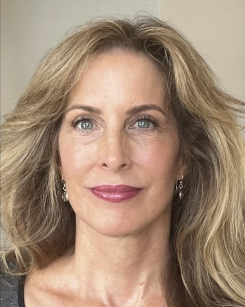 Dr. Leslie Wells, looking directly at the camera, in soft daylight.